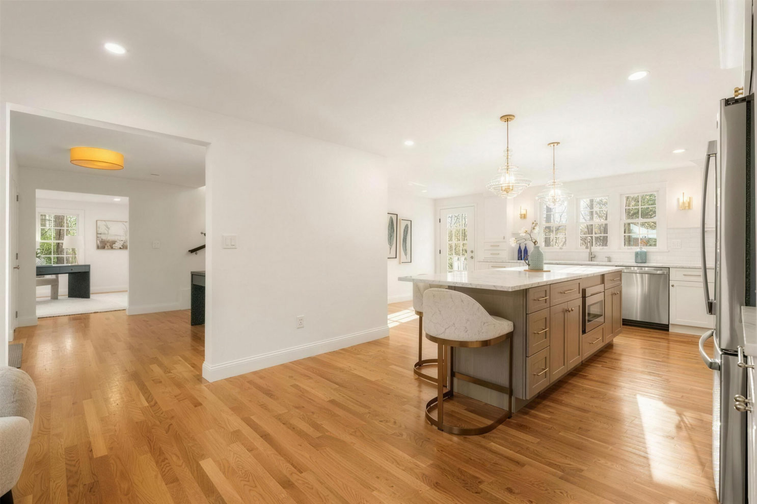 Open-concept kitchen remodel with Fabuwood Desert Oak island, quartz countertop and white oak hardwood floors - Medfield MA