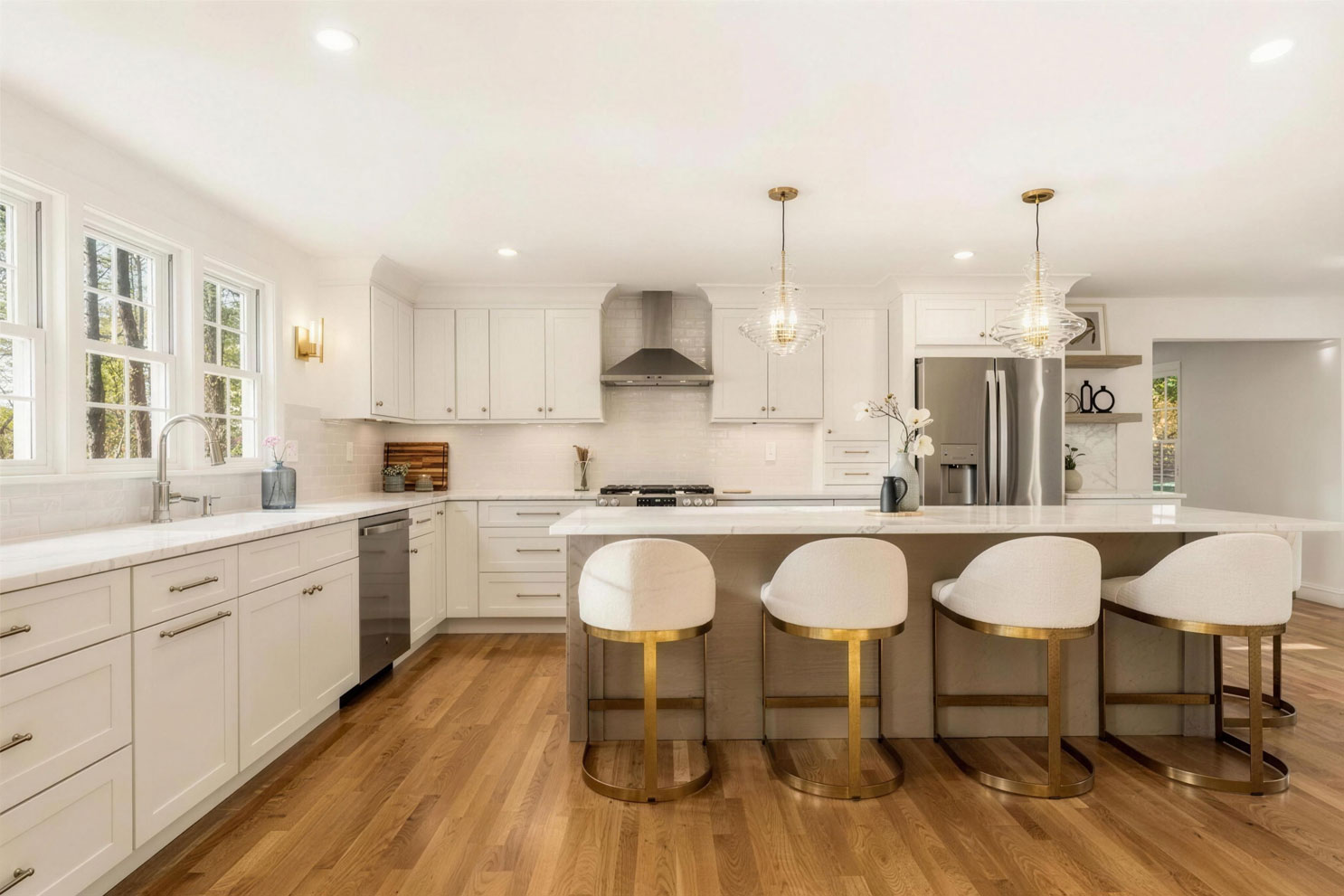 Desert Oak kitchen island with quartz countertop and seating for four, white Fabuwood perimeter cabinets and glass pendant lights - Medfield MA kitchen remodel